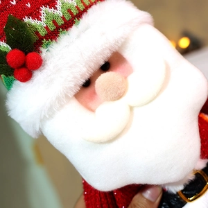 Detail of Santa Claus plush doll featuring knitted textures and soft festive fabrics
