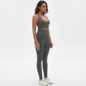 Detail view of seamless dark grey-green yoga set with side waist cutout and cross back
