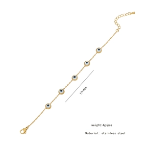Detail view of gold stainless steel bracelet featuring blue and white evil eye charms