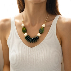 Detail of vintage double-layer necklace with green acrylic beads and marbled pendants