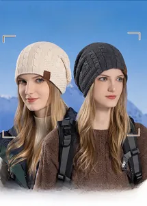 Detailed view of winter knitted hat featuring thick fleece lining and mountain leather label