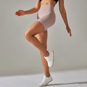 Detail of high-waist mauve yoga shorts showing seamless fabric and compressive fit