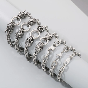 Macro detail of various stainless steel chain bracelets with dragon and snake head clasps