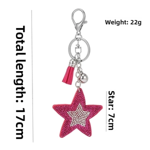 Macro shot of hot pink star keychain with sequins, tassel and dimensions 17cm by 7cm