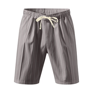 Detail of grey striped drawstring shorts showing elastic waistband and fabric texture