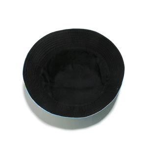 Detailed interior of bucket hat showing smooth black lining and colorful brim pattern