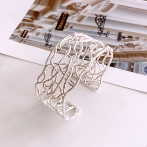 Macro shot of silver-plated crisscross hollow lines on a minimalist open bangle
