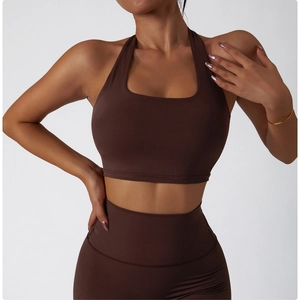 Detail of dark brown yoga set featuring high-waist leggings and halter sports bra