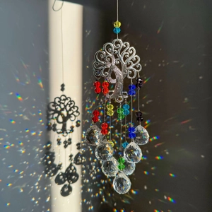 Tree of Life suncatcher with colorful beads and crystal prisms casting rainbow light