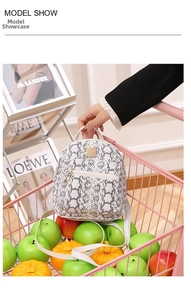 Close-up of a mini snakeskin print backpack featuring a gold brand plate in a shopping basket