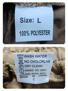 Detail view of clothing wash label and polyester fabric texture on men's jogger pants