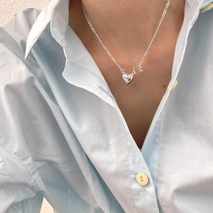 Minimalist 925 sterling silver heart necklace with toggle clasp worn on a model