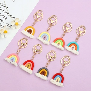 Detailed set of 8 handmade rainbow macrame keychains with colorful cords and white tassels