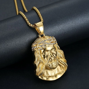 Detailed close-up of a gold-plated Jesus piece pendant with micro-pave diamond crown