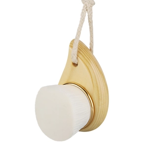 Manual facial cleansing brush with natural wood handle and soft fiber bristles on white background