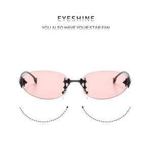 Detail of Y2K star-shaped metallic embellishment on rimless pink oval sunglasses