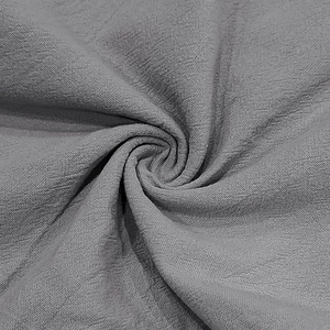 Close-up of grey linen fabric texture showing the natural woven fibers and soft material