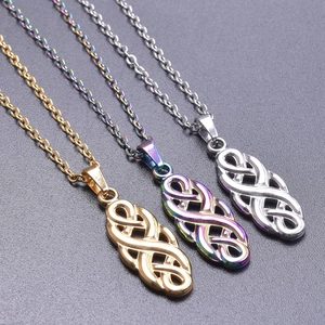 Three-color witch knot pendants in gold, silver, and rainbow finish on gray texture
