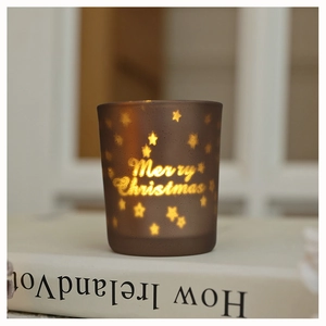 Frosted brown glass candle holder with Merry Christmas lettering and star cutout detail