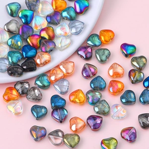 Macro shot of 10mm iridescent heart-shaped glass crystal beads in various vibrant colors