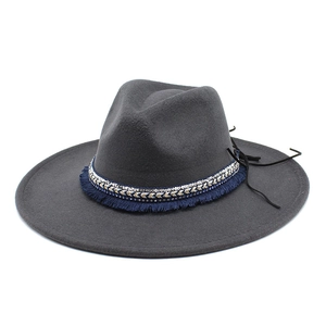 Close-up of dark grey wool felt fedora with blue fringe and silver sequin woven band