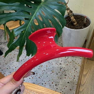 Detail of a large 15cm French red hair claw clip in a glossy finish for thick hair