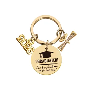 Detail of 2026 graduation keychain with gold scroll and funny engraved circular charm