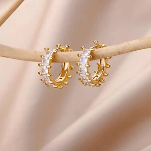 Elegant 18k gold plated hoop earrings with square cubic zirconia on a natural wood branch