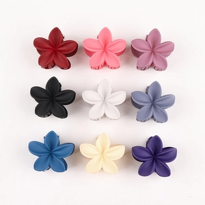 Detail view of nine matte floral hair claws in various colors with a sturdy spring design