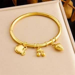 Detail of gold-plated bangle with 3D apple, cherry, and strawberry fruit pendants