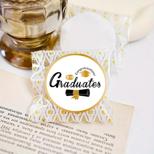 Close-up of transparent Graduation gift bag with yellow dots and black gold logo detail
