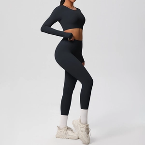 Close-up of black seamless yoga set featuring long sleeve crop top with thumb holes