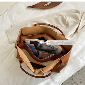 Top view of large brown leather tote bag showing spacious interior and zip pocket