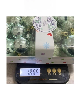 Detailed view of 26pcs teal Christmas ball set in clear packaging weighing 188.9g on a scale