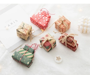 Detailed overhead shot of mini Christmas gift boxes with festive patterns on faux fur