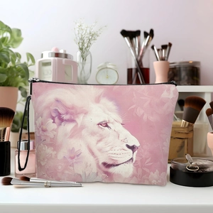 Pink lion floral makeup bag with black zipper and strap on a stylish vanity table