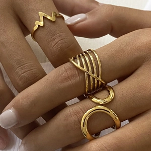 Set of gold stainless steel rings featuring layered crossover and wave patterns for women
