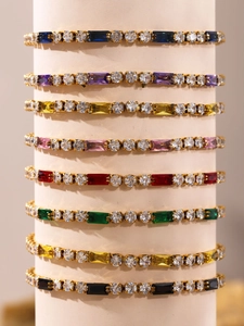 Detail of colorful rectangular zircon tennis bracelets with gold-plated metal setting