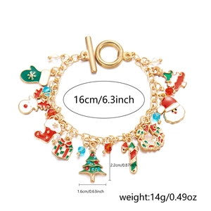 Detailed view of gold Christmas charm bracelet with Santa, reindeer and tree pendants