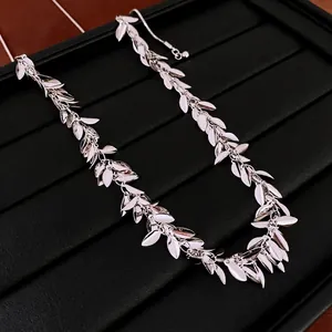 Silver sequin leaf fringe necklace with adjustable chain on a black jewelry tray