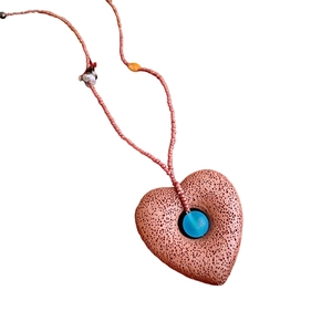 Retro heart pendant necklace with red porous stone texture and blue zircon bead