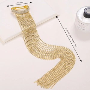Detail view of gold rhinestone tassel hair clip with 15.35 inch long sparkling chains