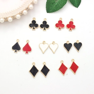 Detailed view of colorful poker card charms featuring heart and spade enamel patterns