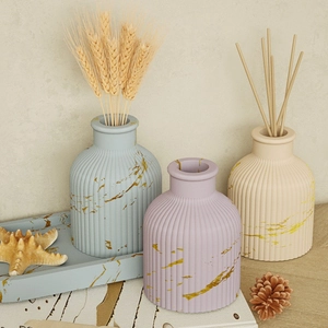 Detailed view of striped resin jars with gold marble veins on a blue matching tray