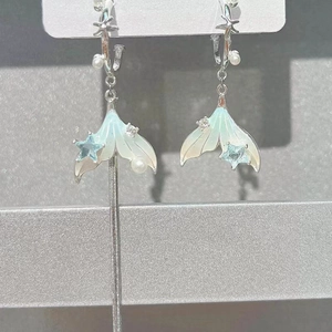 Asymmetric mermaid tail drop earrings with blue star and pearls on silver chain