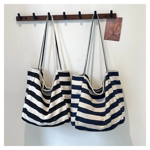 Large capacity striped canvas tote bag in black and blue hanging on a wooden hook