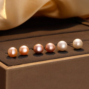 Three pairs of elegant natural freshwater pearl stud earrings in white, pink, and purple colors
