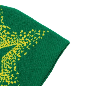 Detailed close-up of dark green knitted fabric with yellow star pattern and stitching