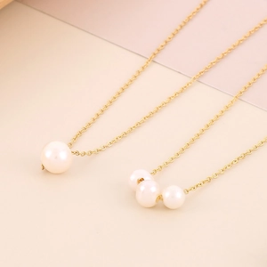 18K gold plated minimalist shell pearl necklaces on a soft geometric pink background