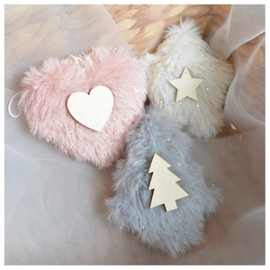 Detailed view of fuzzy plush Christmas ornaments in heart, star, and tree shapes with gold tinsel